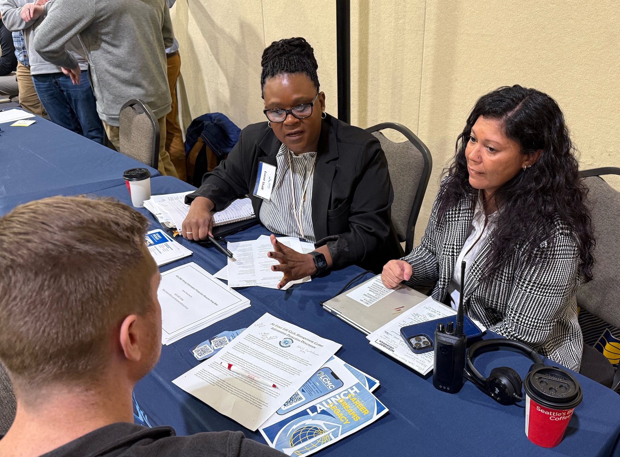Recruiters from Hill Air Force Base meet with job seekers at a hiring event Jan. 16 at the Davis Conference Center. Job seekers were able to meet with representatives from several base organizations and multiple candidates received job offers. (U.S. Air Force photo by Kendahl Johnson)
