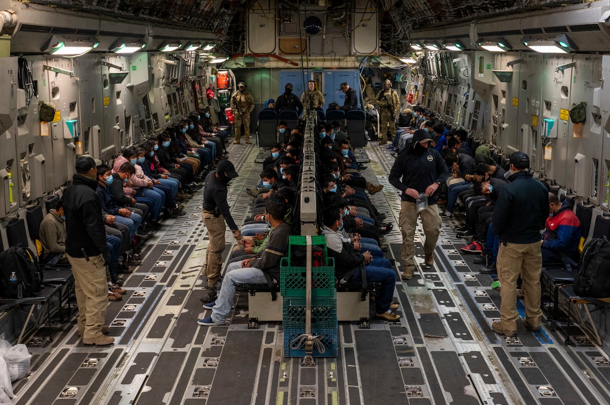 Illegal aliens await takeoff for a removal flight.