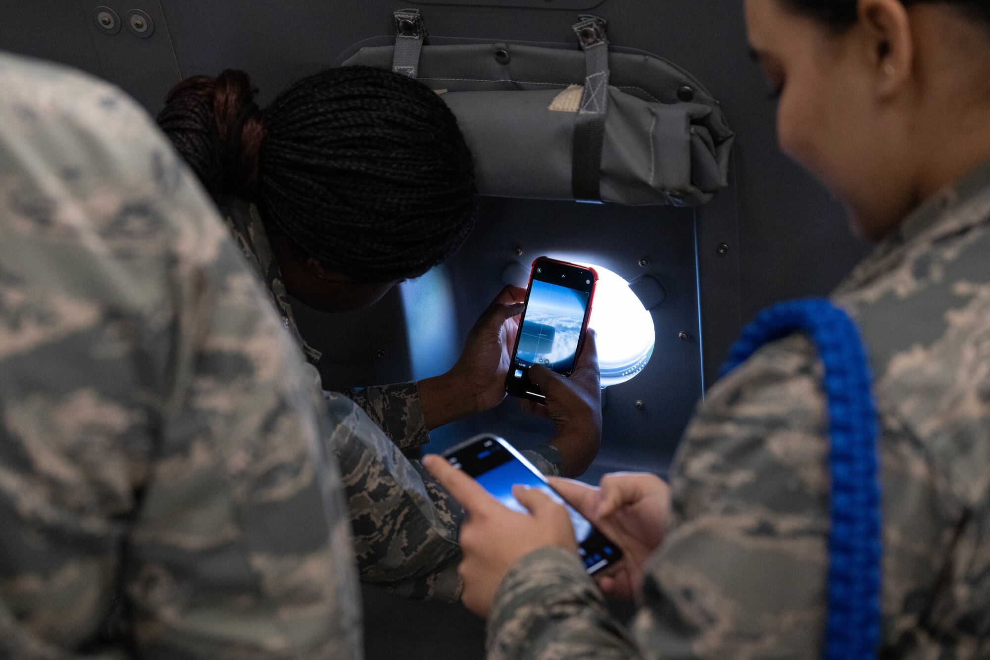 Students from Mount Olive High School Junior Reserve Officers' Training Corps take photos of a KC-46A Pegasus’ wing while flying over Joint Base McGuire-Dix-Lakehurst, N.J., Jan. 14, 2025. JROTC Students from Mount Olive High School flew on the 2nd Aerial Refueling Squadron’s KC-46A as a part of the Aviation Inspiration Mentorship program to enhance their understanding of the Air Force’s aviation mission. (U.S. Air Force photo by Senior Airman Aidan Thompson)