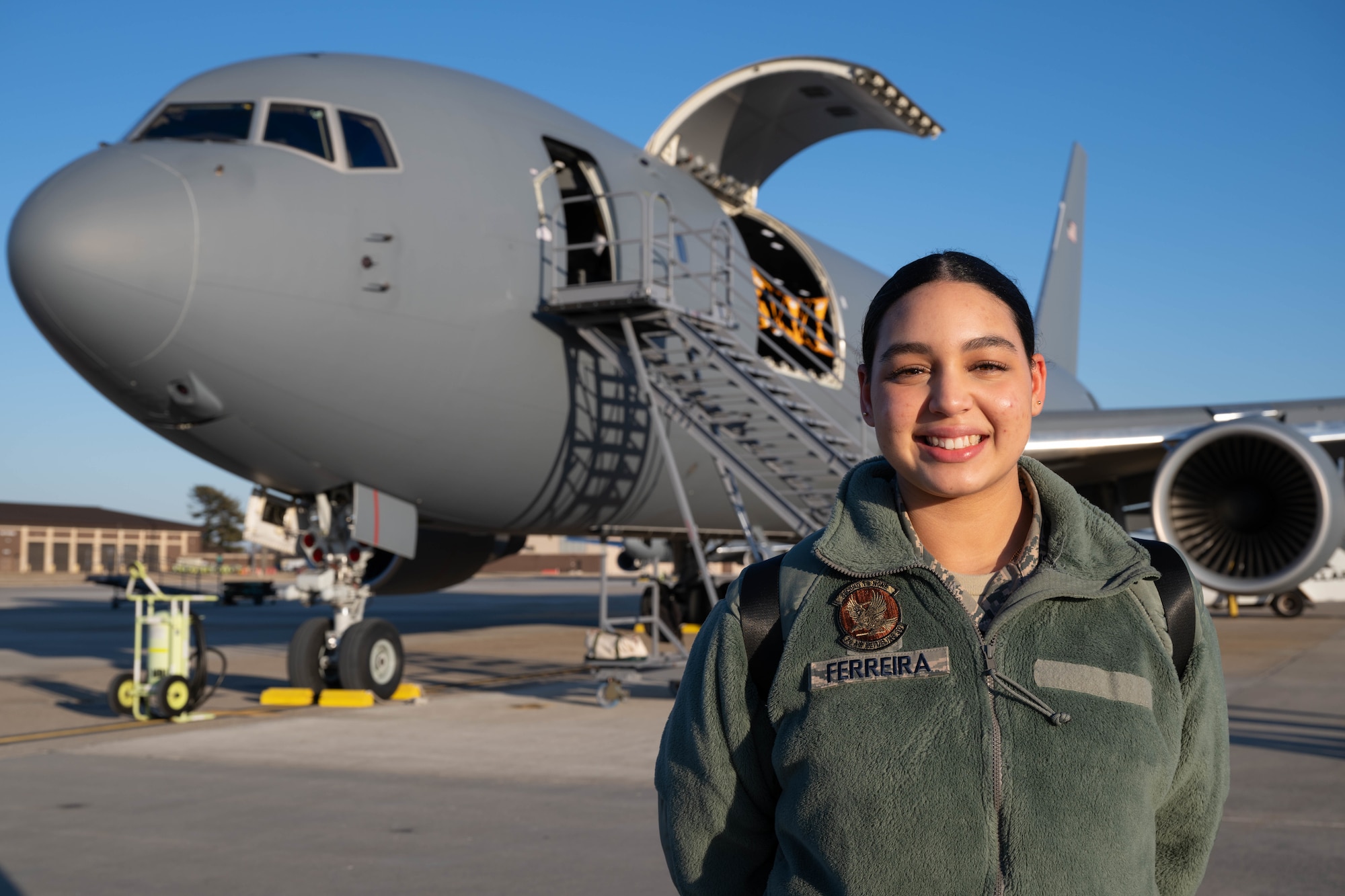 Cyara Ferreira, Mount Olive High School JROTC Bravo Flight Kitty Hawk Honor Society commander, poses for a photo in front of a KC-46A Pegasus aircraft at Joint Base McGuire-Dix-Lakehurst, N.J., Jan. 14, 2025. JROTC Students from Mount Olive High School flew on the 2nd Aerial Refueling Squadron’s KC-46A as part of the Aviation Inspiration Mentorship program to enhance their understanding of the Air Force’s aviation mission. (U.S. Air Force photo by Senior Airman Aidan Thompson)