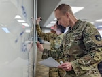 Sgt. Maj. Gregory Byrd, the operations sergeant major for the 1st Armored Brigade Combat Team, 34th Red Bull Infantry Division, conducts mission analysis with a group of staff officers during annual training at Camp Ripley.