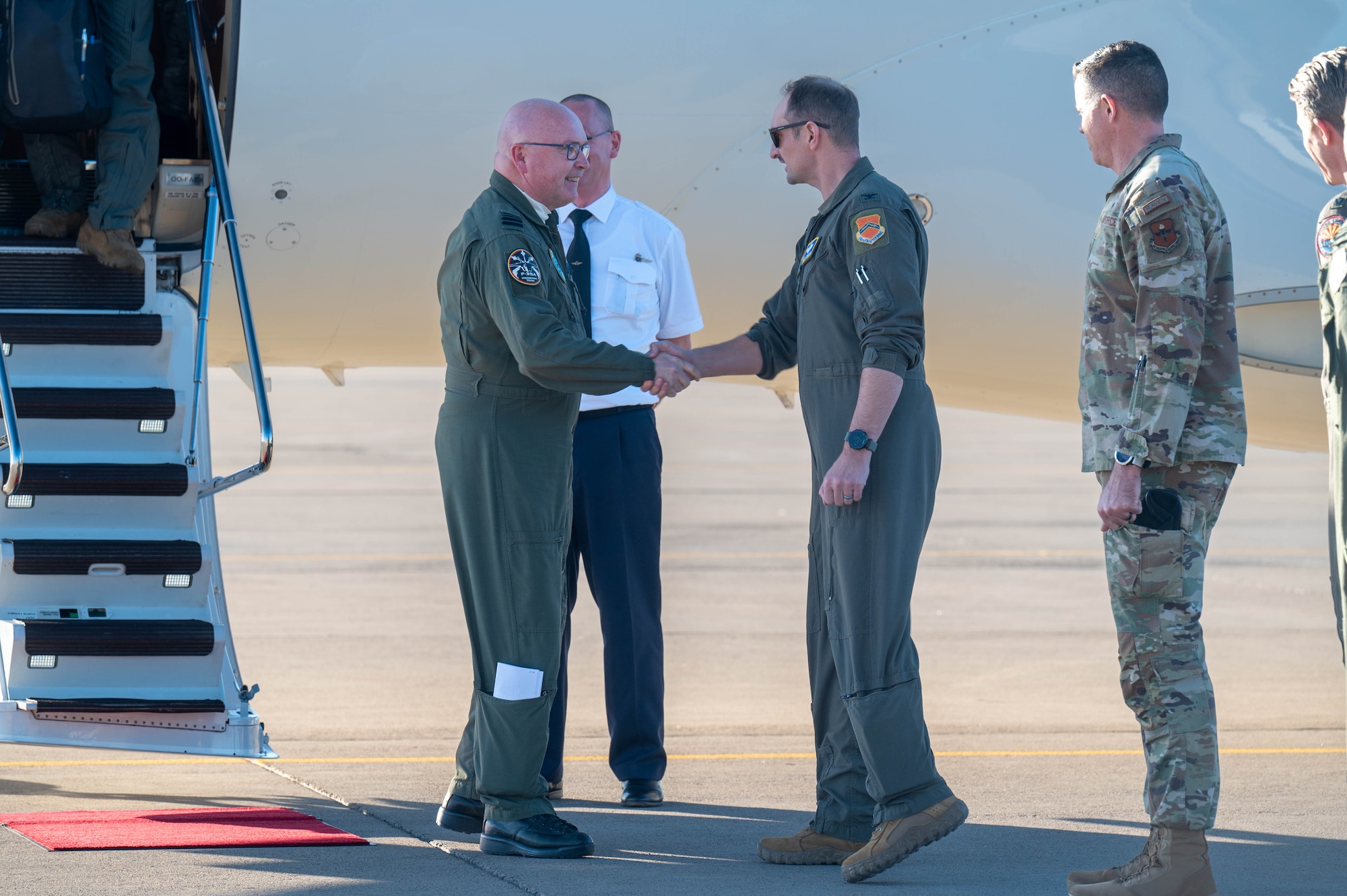 U.S. Air Force Col. Matthew Johnston (center-right), 56th Fighter Wing deputy commander, greets Belgian Air and Space Component Maj. Gen. Theirry Dupont (left), BASC commander, as he arrives at Luke Air Force Base, Arizona,