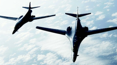 Two B-1B Lancers assigned to Ellsworth Air Force Base, South Dakota, fly in formation above Gulf of Mexico.