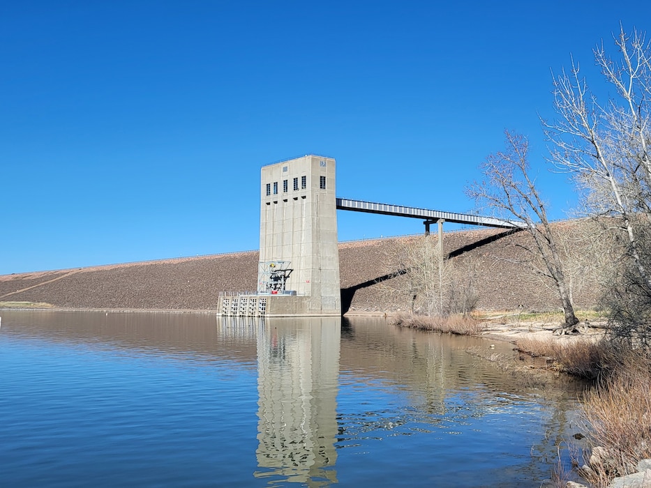 The Cherry Creek Dam outlet manages reservoir levels by releasing water from the reservoir to downstream users. Release rates are generally less than 100 cubic feet of water per second. The outlet structure can release water at a rate of up to 10,000 cfs. when operating to reduce flood risks during periods of high runoff. One cubic foot of water, or cfs, is equivalent to 7.5 gallons.