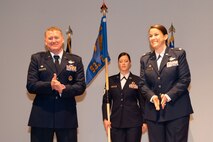 U.S. Air Force Col. Michael Lynch, 461st Operations Group commander, and Lt. Col. Nicole Ketron, 932nd Battle Management Control Squadron (BMCS) on stage at the activation and assumption of command ceremony for the 932nd BMCS at the Community Activity Center at Beale Air Force Base, California, Jan 23, 2024.