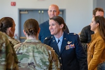 U.S. Air Force Lt. Col. Nicole Ketron, 932nd Battle Management Control Squadron commander meets with guests at the conclusion of the activation and assumption of commander ceremony in the Community Activity Center at Beale Air Force Base, California, Jan 23, 2025.
