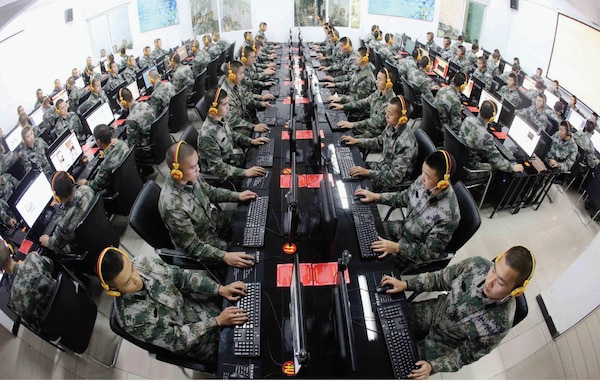 Chinese soldiers browse news on desktop computers at People’s Liberation Army garrison in Chongqing, China, November 14, 2013.