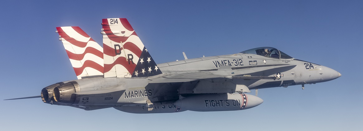 Marine F/A-18s fly over the Pacific