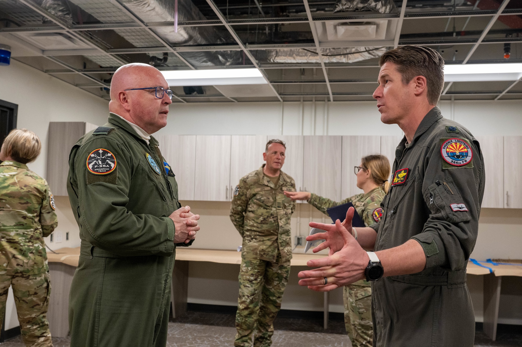 Belgian Air and Space Component Maj. Gen. Thierry Dupont (left), BASC commander, speaks with Lt. Col. Jason Wall (right), 312th Fighter Squadron commander, during a tour of the 312th FS’s newly renovated building, Jan. 16, 2025, at Luke Air Force Base, Arizona.