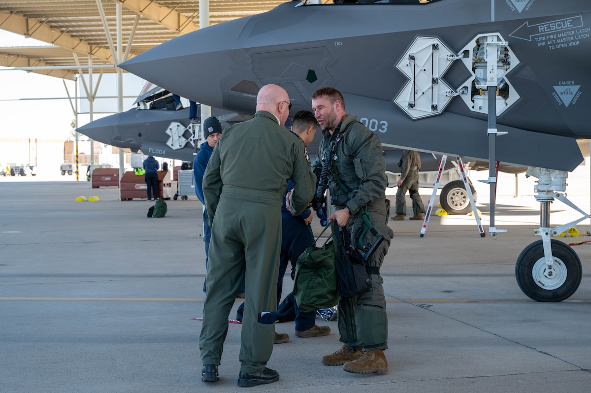 Belgian Air and Space Component Maj. Gen. Thierry Dupont (left), BASC commander, greets Lt. Col. Pierre-Yves Libert (right), 312th Fighter Squadron senior national representative, after his flight during a base visit, Jan. 15, 2025, at Luke Air Force Base, Arizona.