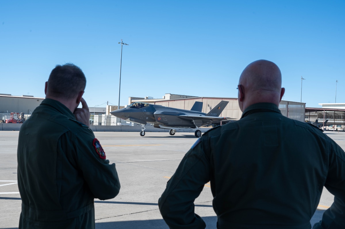 Belgian Air and Space Component Maj. Gen. Thierry Dupont (right), BASC commander, and Lt. Col. Pierre-Yves Libert (left), 312th Fighter Squadron senior national representative, observe a Belgian F-35A Lightning II taxi from the runway, Jan. 14, 2025, at Luke Air Force Base, Arizona.
