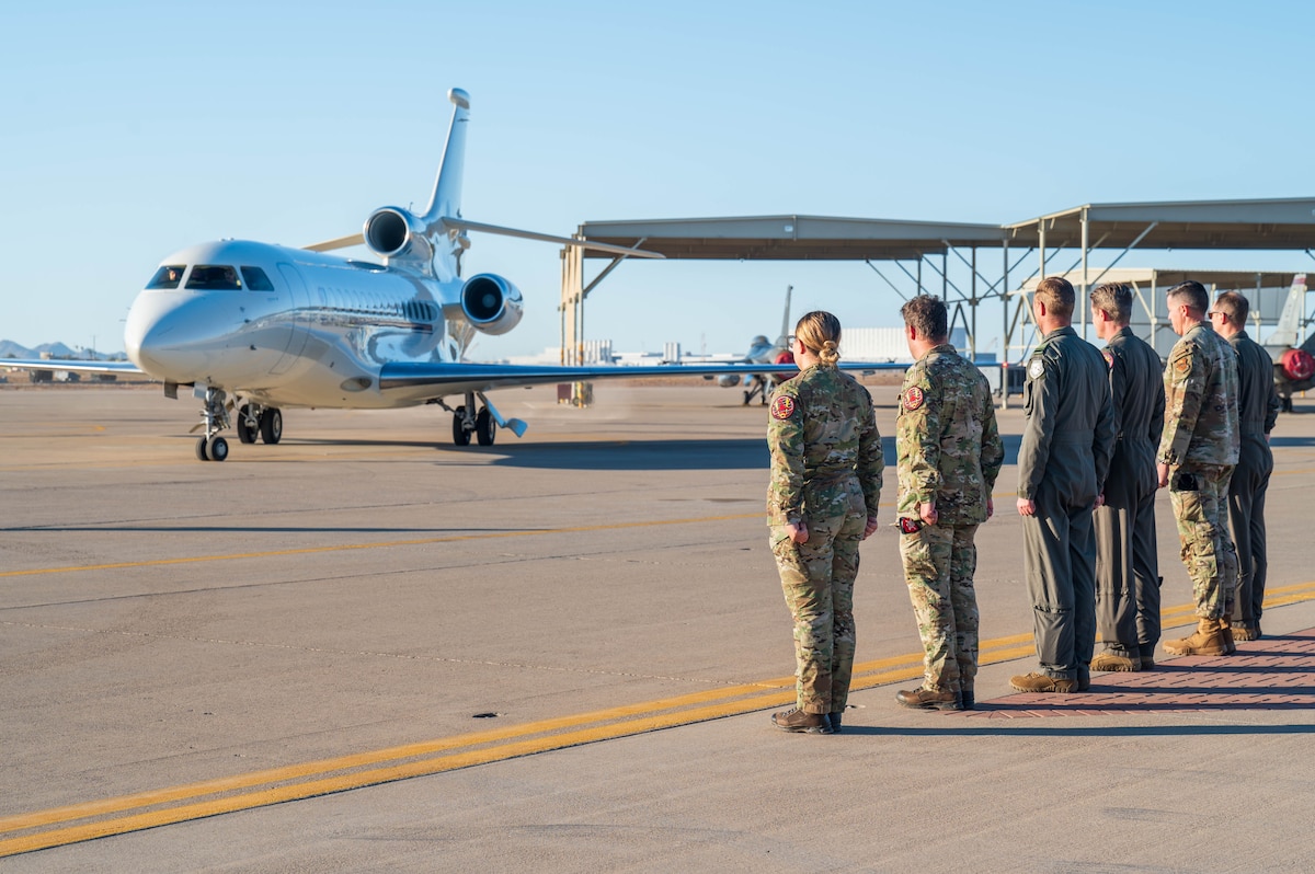 U.S. Air Force Col. Matthew Johnston (far right), 56th Fighter Wing deputy commander, and Chief Master Sgt. Jason Shaffer (second to right), 56th FW command chief, stand alongside members of the 312th Fighter Squadron as Maj. Gen. Theirry Dupont, Belgian Air and Space Component commander, arrives at Luke Air Force Base, Arizona, Jan. 13, 2025.