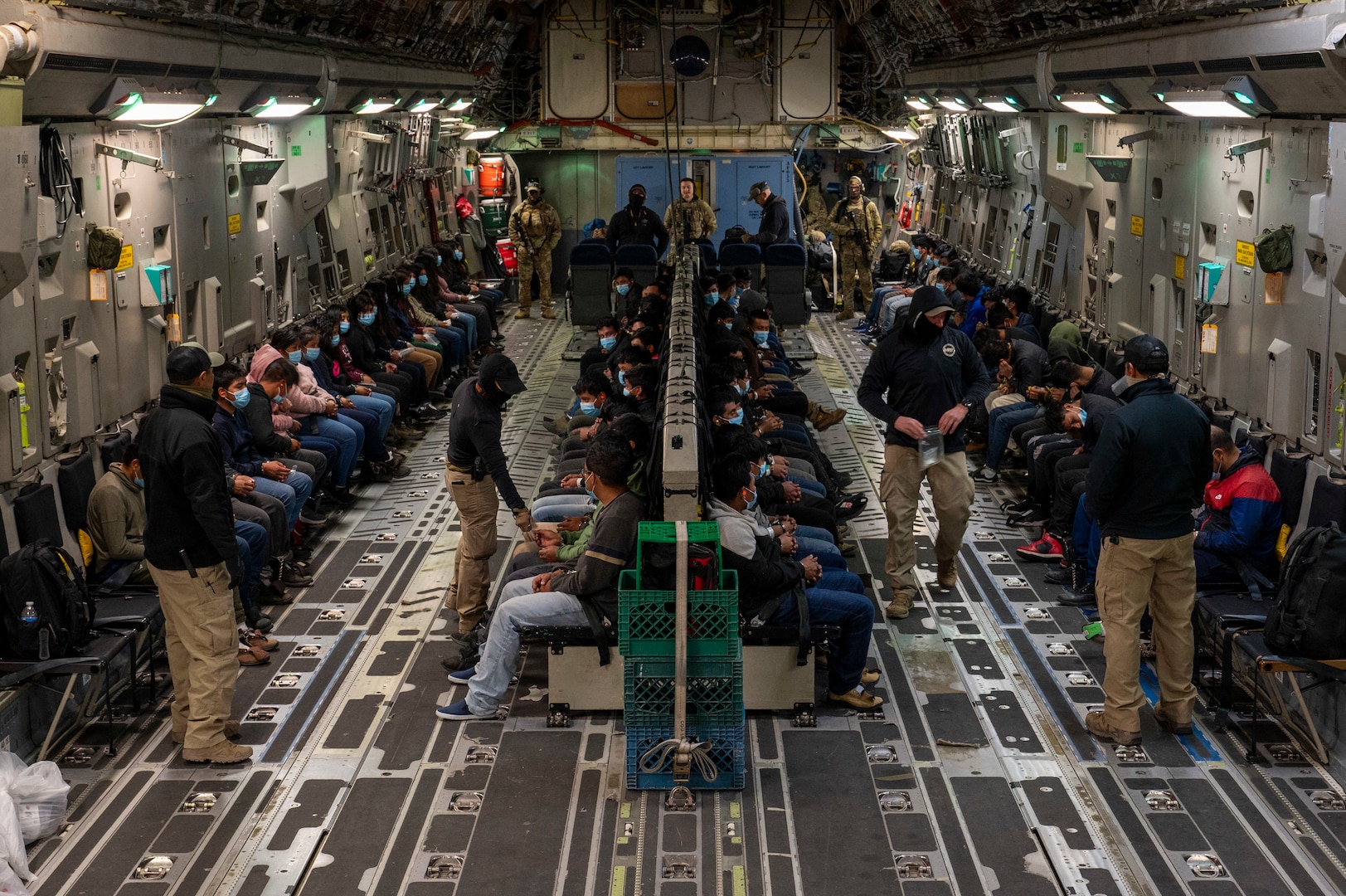 Illegal aliens await takeoff for a removal flight.