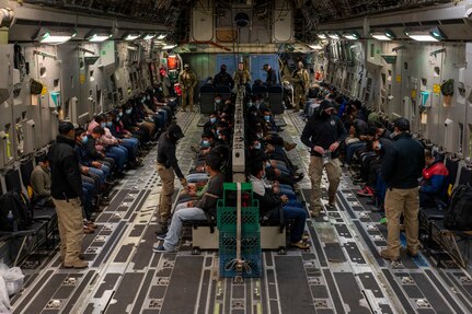Illegal aliens await takeoff for a removal flight.