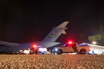 Airmen and agents prepare to load illegal aliens onto an aircraft.