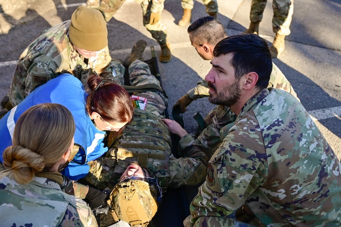 Medical personnel tend to wounded patient