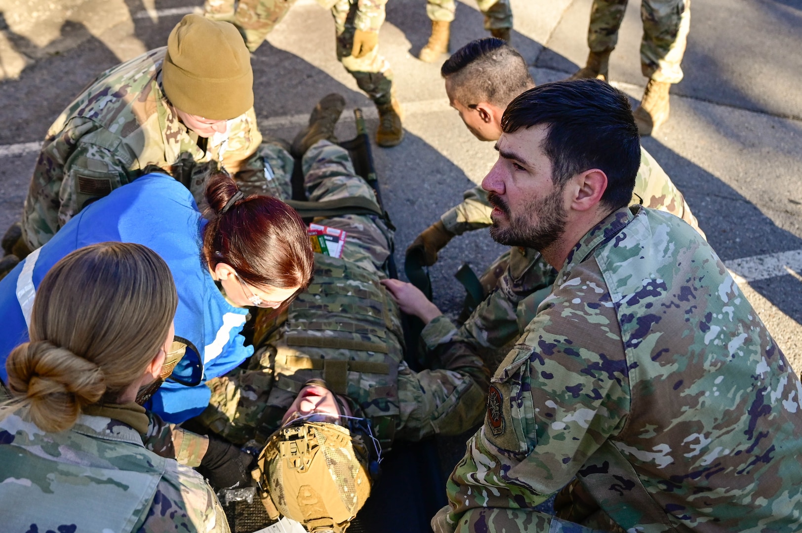 Medical personnel tend to wounded patient