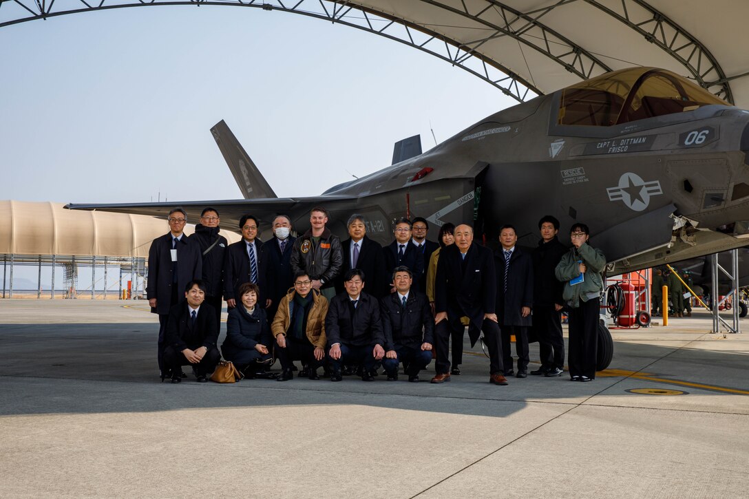 U.S. Marine Corps Capt. Louis Kocina, a pilot with Marine Fighter Attack Squadron (VMFA) 121, Marine Aircraft Group 12, 1st Marine Air Wing, and a native of California, and leadership from Iwakuni City, Misawa Air Base and Misawa City pose for a group photo in front of a U.S. Marine Corps F-35B Lightning II aircraft with VMFA-121, MAG 12, 1st MAW, during a visit to Marine Corps Air Station Iwakuni, Jan. 22, 2025. Leadership from Iwakuni City, Misawa Air Base and Misawa City visited MCAS Iwakuni to observe its relationship to the local community and improve mutual understanding. (U.S. Marine Corps photo by Lance Cpl. David Getz)