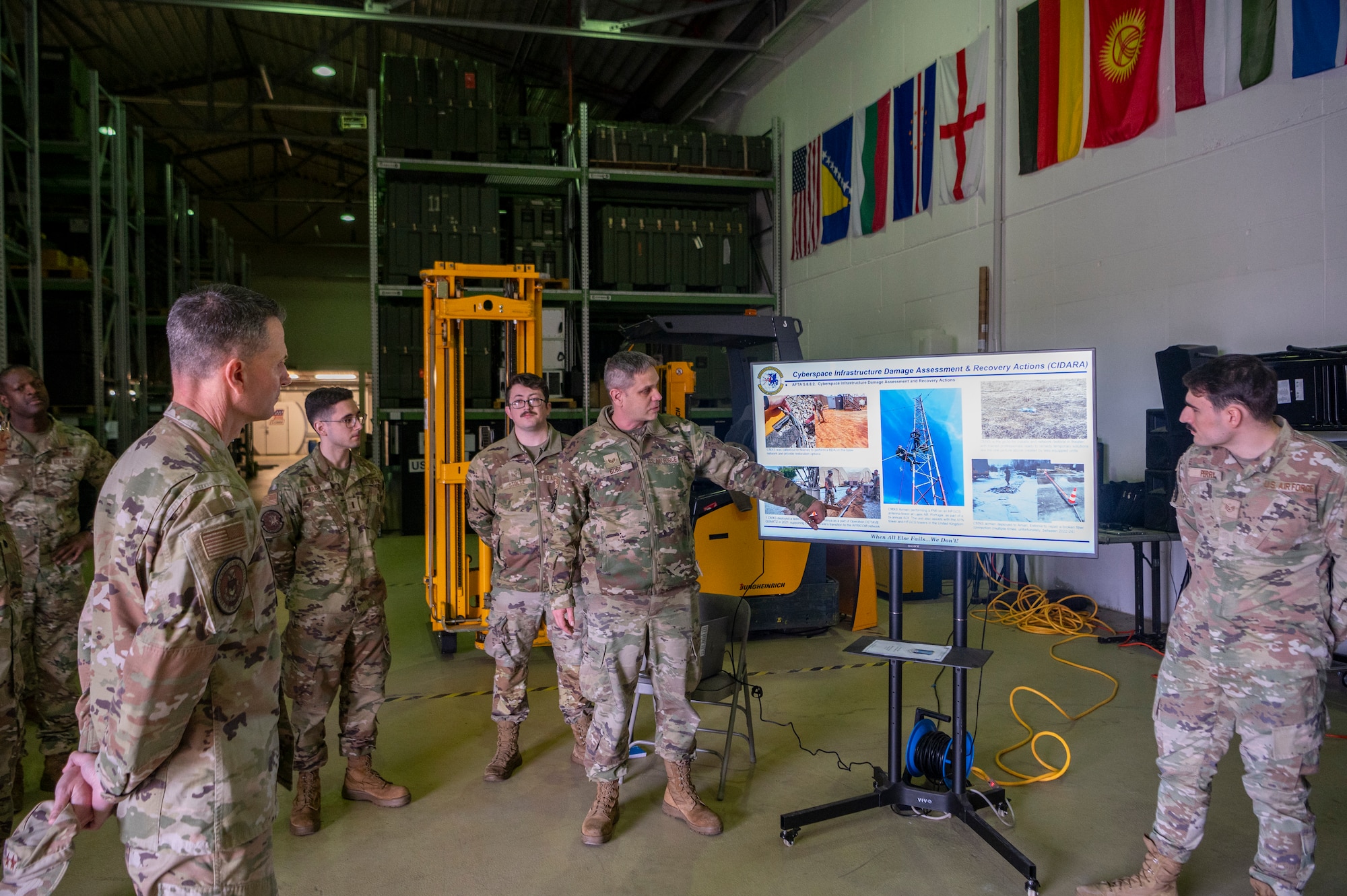 U.S. Air Force Staff Sgt. Richard Bure, 1st Communications Maintenance Squadron logistics supervisor, outlines the 1st CMXS’s mission to U.S. Air Force Maj. Gen. Trent C. Davis, left, Headquarters U.S. Air Force chief of chaplains, at Ramstein Air Base, Germany, Jan. 24, 2025.