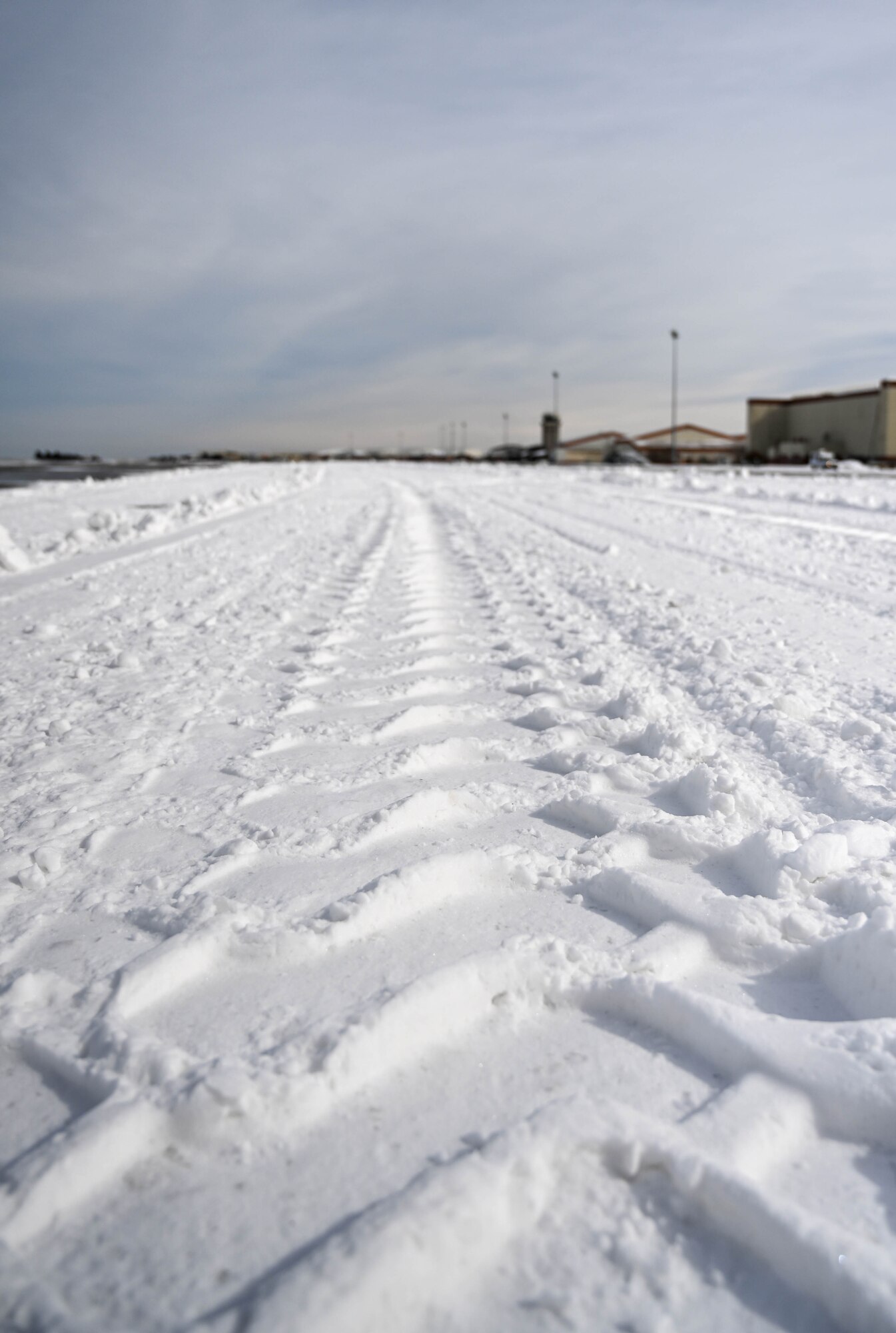 Tire tracks in snow on flightline