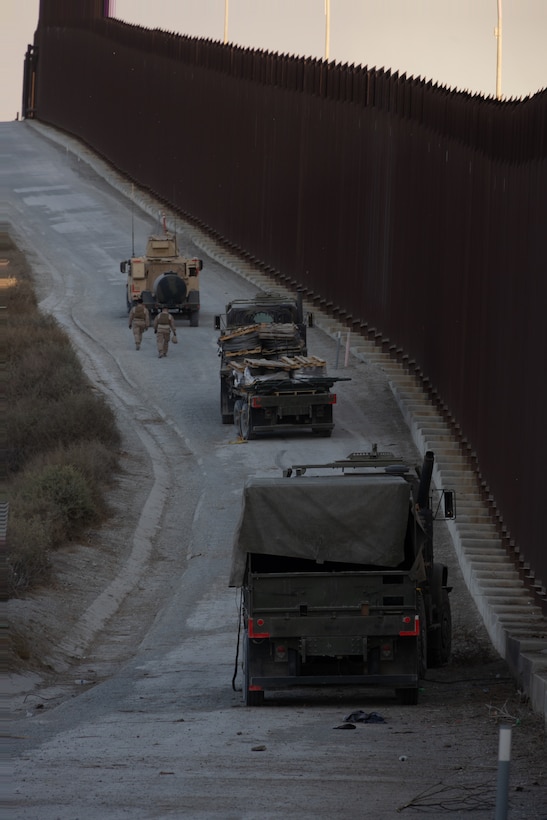 U.S. Marines with 1st Marine Division drive tactical vehicles along the southern border near San Ysidro, California, Jan. 23, 2025. U.S. Northern Command is working together with the Department of Homeland Security with the emplacement of temporary physical barriers to add additional security that will curtail illegal border crossings. (U.S. Marine Corps photo by Cpl. Logan Courtright)