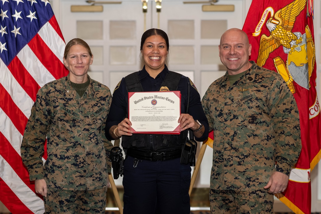 Chellsie J. Sanjurjo-Jones, a school recourse officer with the Provost Marshall Office, poses with U.S. Marine Corps Col. Jenny Colegate, commanding officer of Marine Corps Base Quantico, left, and Sgt. Maj. Michael R. Brown, sergeant major of MCBQ, during the Civilian Quarterly Awards at The Clubs at Quantico, MCBQ, Virginia, January 23, 2025. Sanjurio-Jones was recognized with the Junior Appropriated Fund Personnel Civilian Employee of the Year for work done in 2024. (U.S. Marine Corps photo by Lance Cpl. David Brandes)
