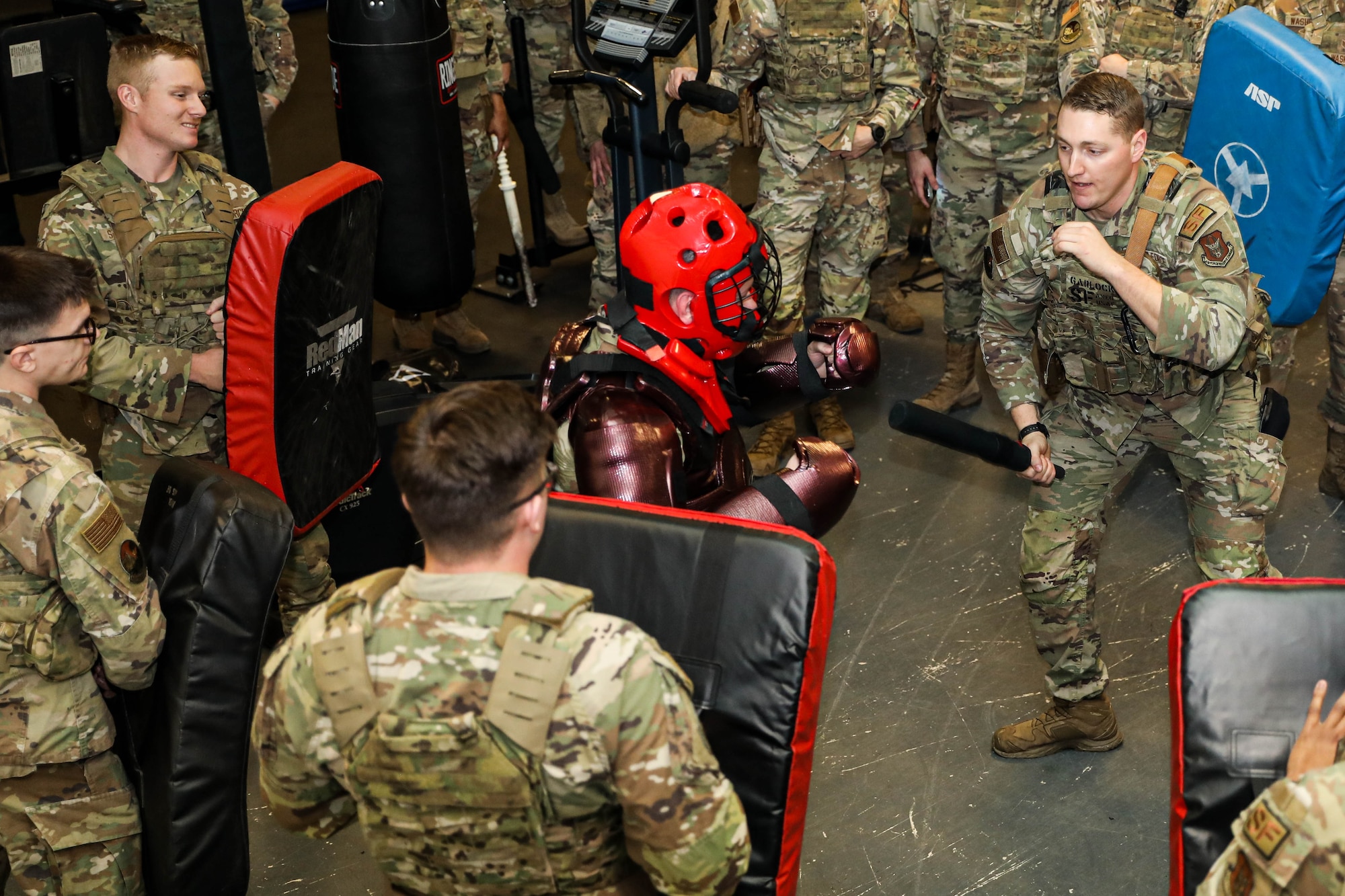 Members of the 445th Security Forces Squadron take turns defending against an attacker in a "Red Man" suit as a part of expandable baton certification training at Wright-Patterson Air Force Base, Jan. 12, 2025. The baton is a non-lethal defensive weapon used against actively non-compliant subjects.
