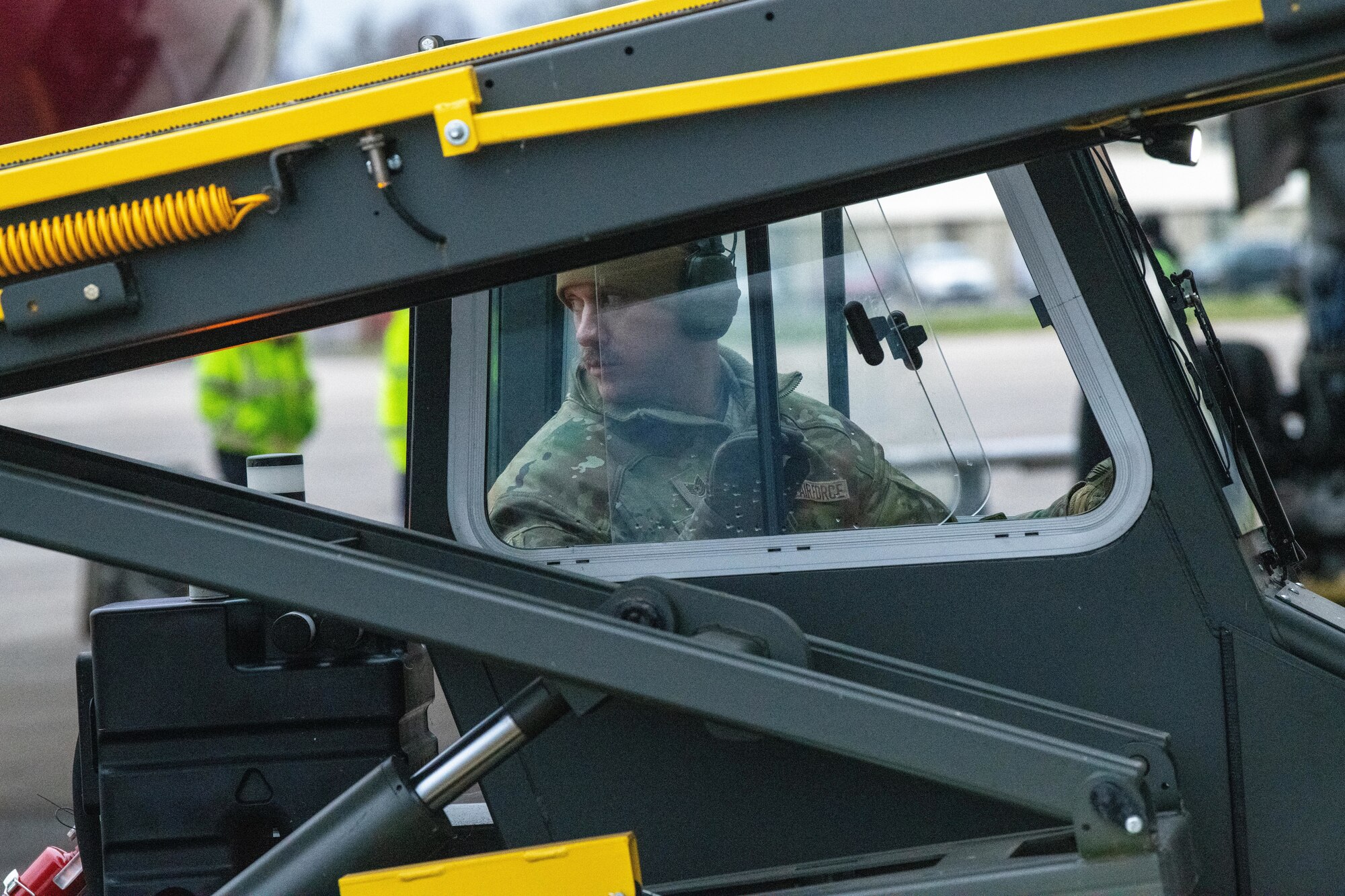 Airman drives a baggage conveyor
