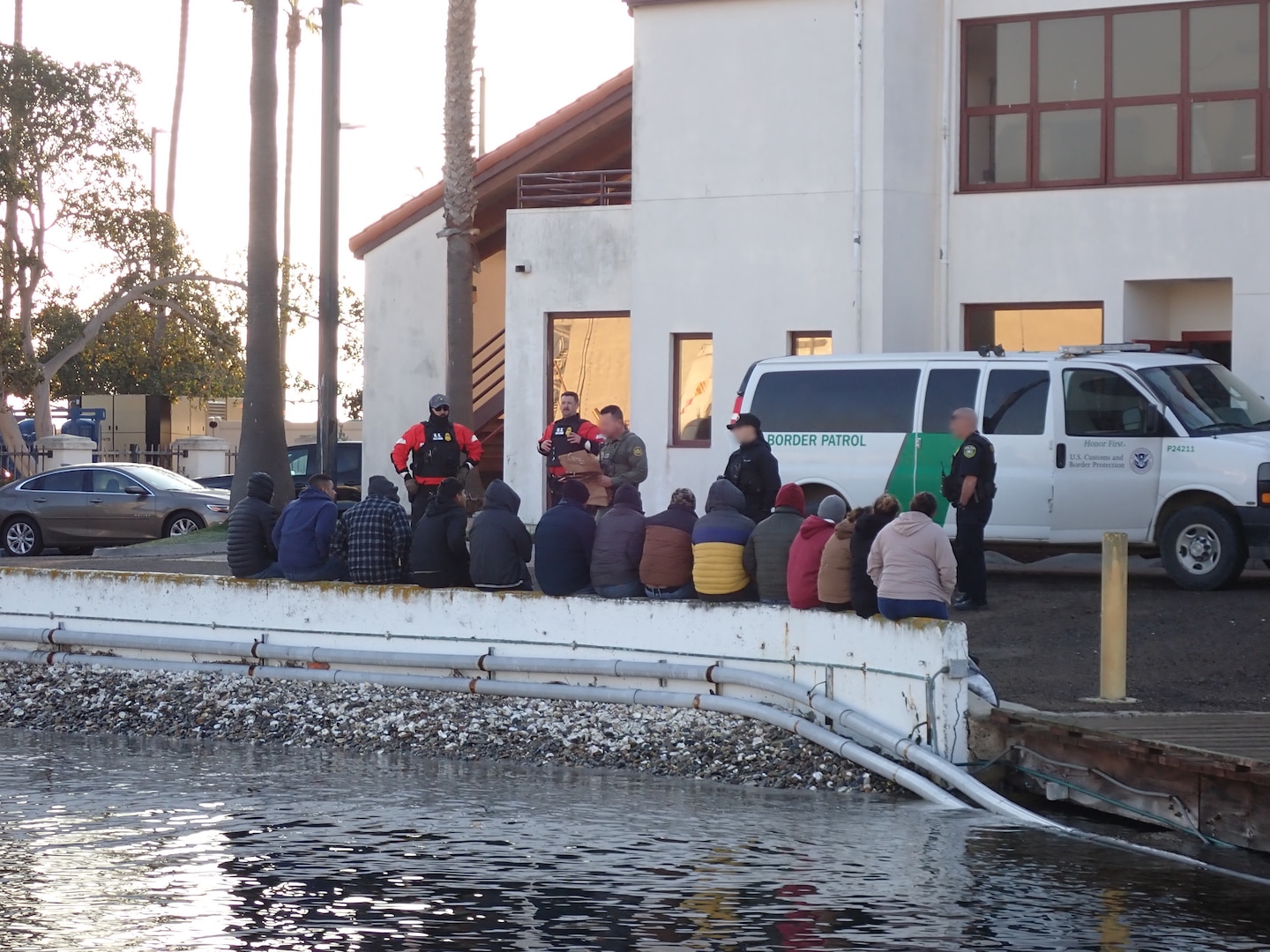 Coast Guard and partnership agencies process individuals ashore following the interdiction of a migrant vessel approximately 20 miles off the coast of Point Loma, California, Jan. 28, 2025