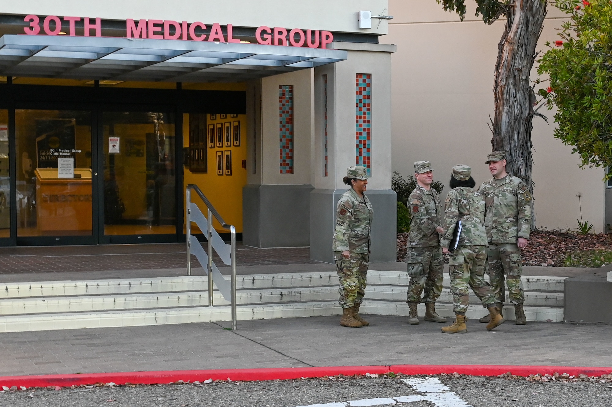 People stand outside the 30th medical group clinic.
