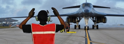 ANDERSEN AIR FORCE BASE, Guam (Jan. 27, 2025) — U.S. Air Force Senior Airman Andre Monterrosa, 34th Expeditionary Bomb Squadron assistant dedicated crew chief, marshals a B-1B Lancer through a clear water rinse at Andersen Air Force Base, Guam, Jan. 27, 2025, in support of Bomber Task Force 25-1. The United States is an Indo-Pacific nation and will remain engaged in the region to support U.S. allies and partners in the goal of maintaining a free and open Indo-Pacific. (U.S. Air Force photos by Senior Airman Brittany Kenney)