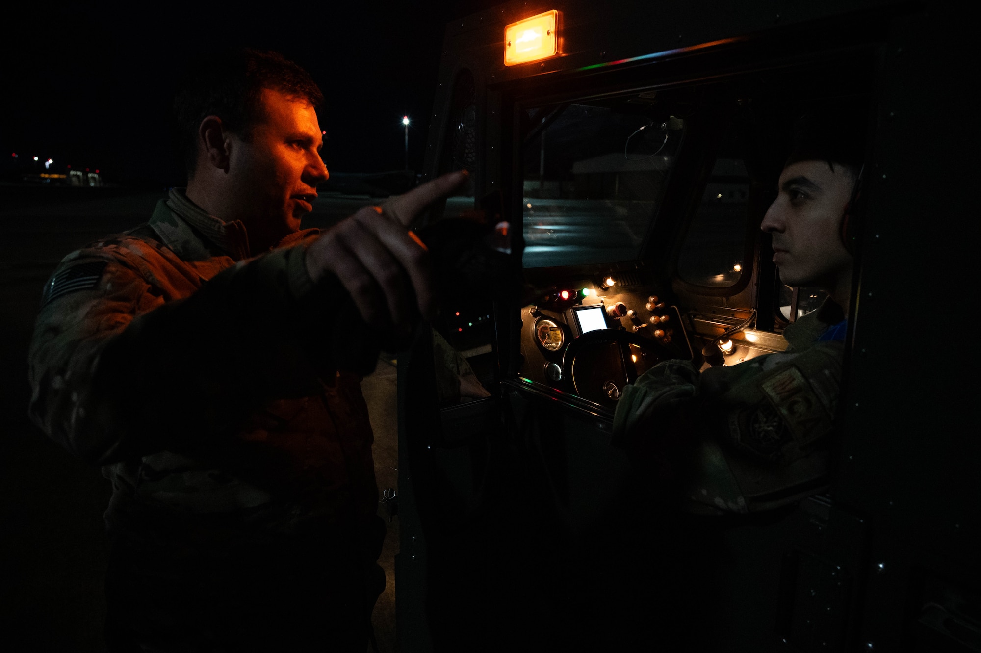 U.S. Air Force Tech. Sgt. Anthony Conn, 758th Airlift Squadron loadmaster assigned to Pittsburgh Air Reserve Station, instructs U.S. Air Force Senior Airman Mayde Romero, 721st Aerial Port Squadron driver, during a C-130J Super Hercules aircraft wing delivery at Ramstein Air Base, Germany, Jan. 25, 2025. A custom fixture was created to enable the air transportation of this specific aircraft wing to Ramstein. (U.S. Air Force photo by Senior Airman Jared Lovett)