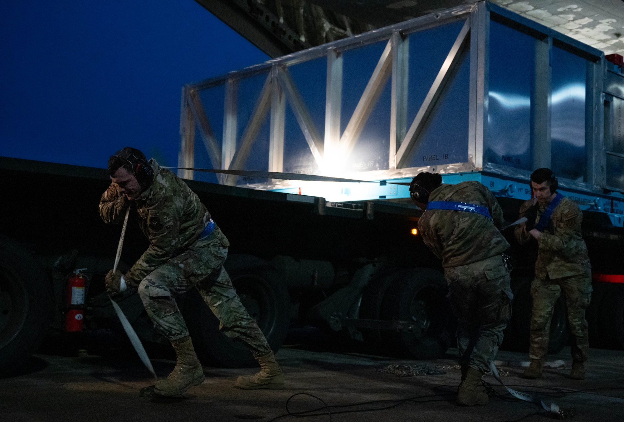 U.S. Airmen assigned to the 721st Aerial Port Squadron offload a C-130J Super Hercules aircraft wing from a C-17 Globemaster III at Ramstein Air Base, Germany, Jan. 25, 2025. The wing was transported via aircraft from Dobbins Air Reserve Base, Georgia, and marked the first airlift operation of this specific aircraft wing. (U.S. Air Force photo by Senior Airman Jared Lovett)
