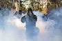 U.S. Marines with II Marine Expeditionary Force Support Battalion, II MEF Information Group, walk through chlorobenylidene malononitrile during a battalion field exercise at Marine Corps Base Camp Lejeune, North Carolina, Jan. 8, 2025. The battalion FEX was designed to increase proficiency in individual and crew-served marksmanship, basic combat skills and improve chemical, biological, radiological, and nuclear readiness. (U.S. Marine Corps photo by Sgt. Jacquilyn Davis)