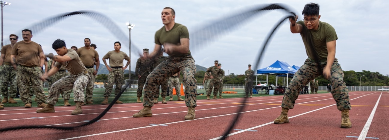 U.S. Marines and Sailors with Marine Corps Installations Pacific use the battle ropes during the Pacific Iron Challenge on Camp Hansen, Okinawa, Japan, Jan. 23, 2024.