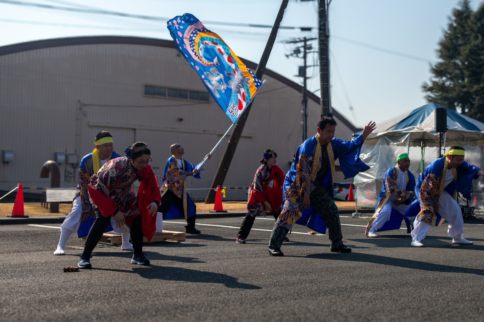 Performers dressed in colorful, traditional Japanese clothing perform a dance.