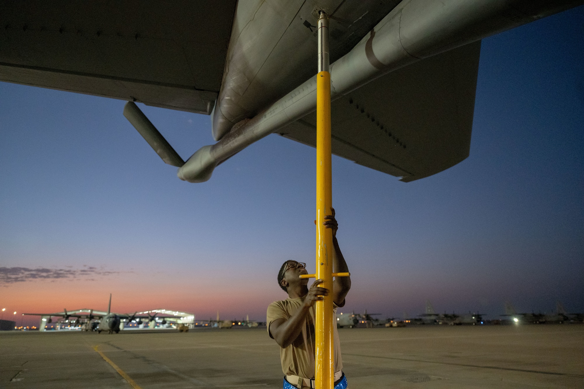 U.S. Air Force Staff Sgt. Tevin Patterson, 97th Expeditionary Air Refueling Squadron crew chief, applies a tail stand to the back of a KC-135 Stratotanker within the U.S. Central Command area of responsibility, Jan. 23, 2025.