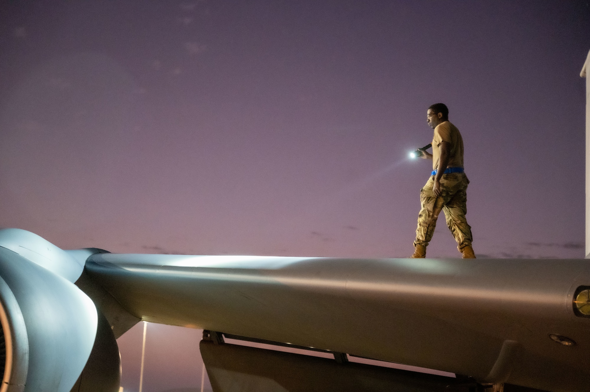 U.S. Air Force Staff Sgt. Tevin Patterson, 97th Expeditionary Air Refueling Squadron crew chief, performs an inspection of a wing of a KC-135 Stratotanker within the U.S. Central Command area of responsibility, Jan. 23, 2025.