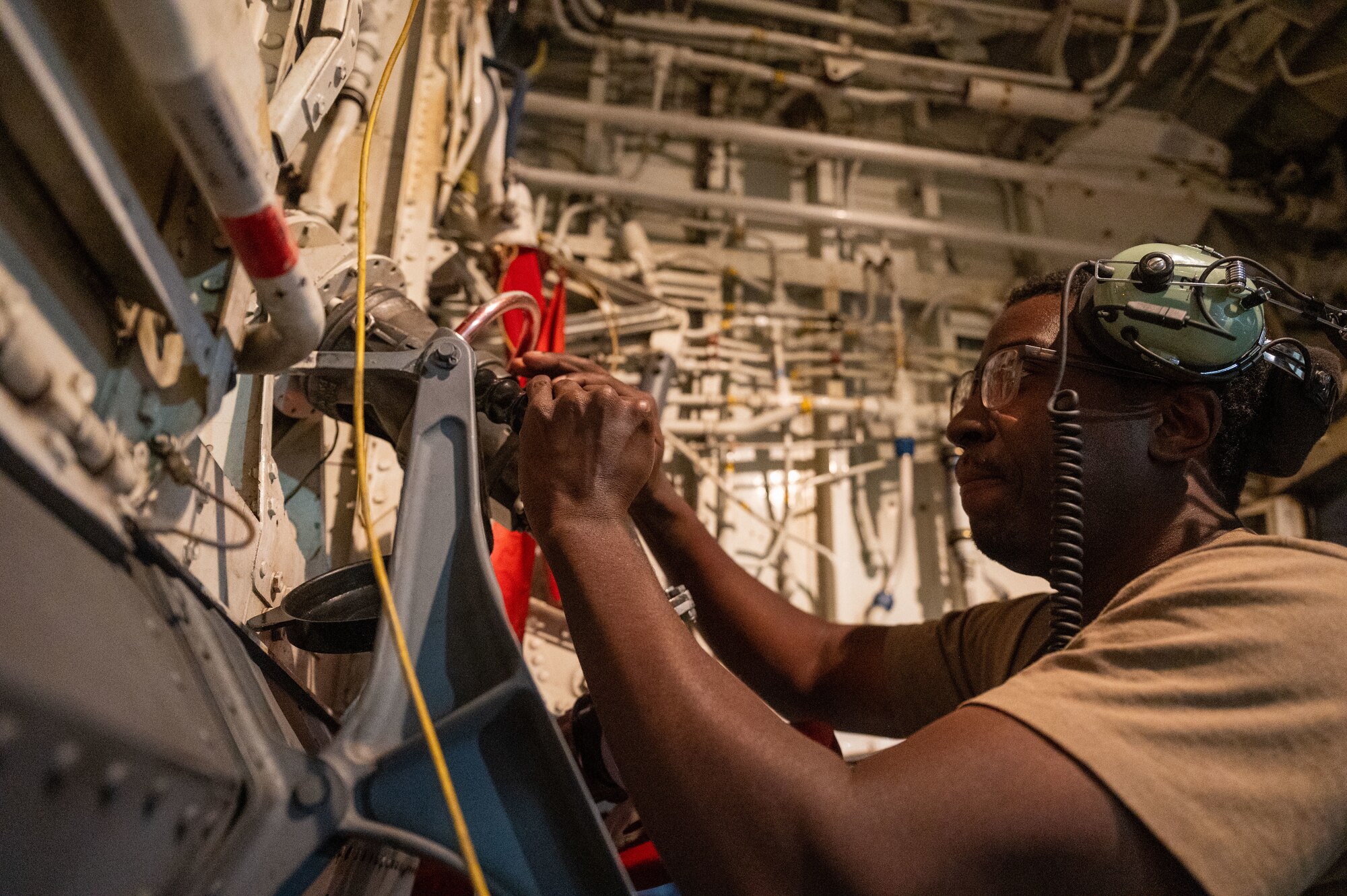 U.S. Air Force Staff Sgt. Tevin Patterson, 97th Expeditionary Air Refueling Squadron crew chief, tightens a fuel pump to a KC-135 Stratotanker within the U.S. Central Command area of responsibility, Jan. 23, 2025