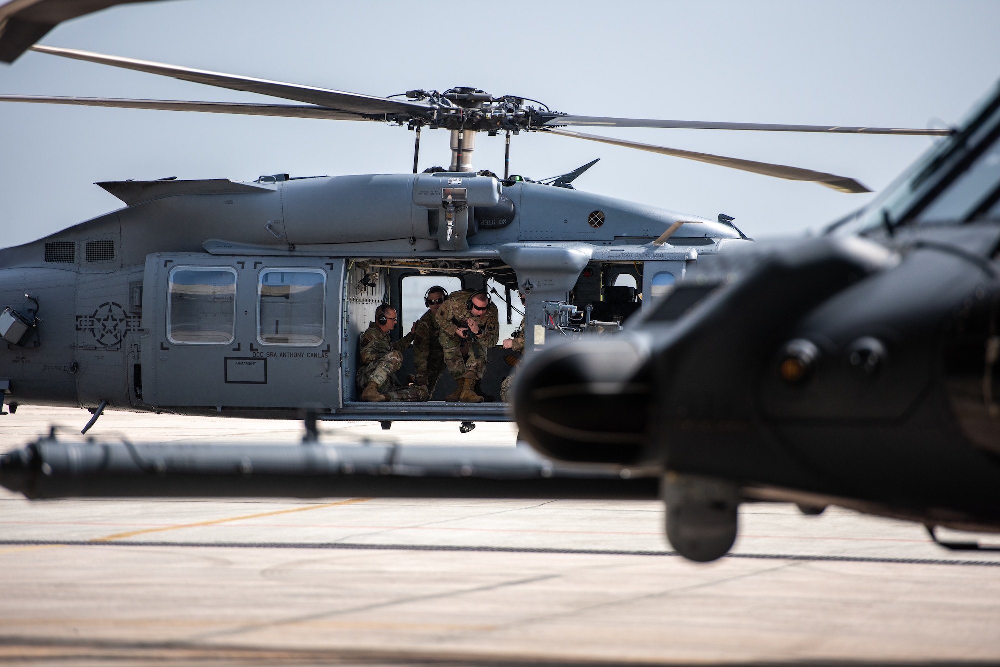 U.S. Air Force Col. Randy Schwindler, 18th Maintenance Group commander, and U.S. Air Force Maj. Sean D. Massey, incoming 33rd Rescue Generation Squadron commander, disembark from a HH-60W Jolly Green II for the squadron activation ceremony at Kadena Air Base, Japan, Jan. 24, 2025.
