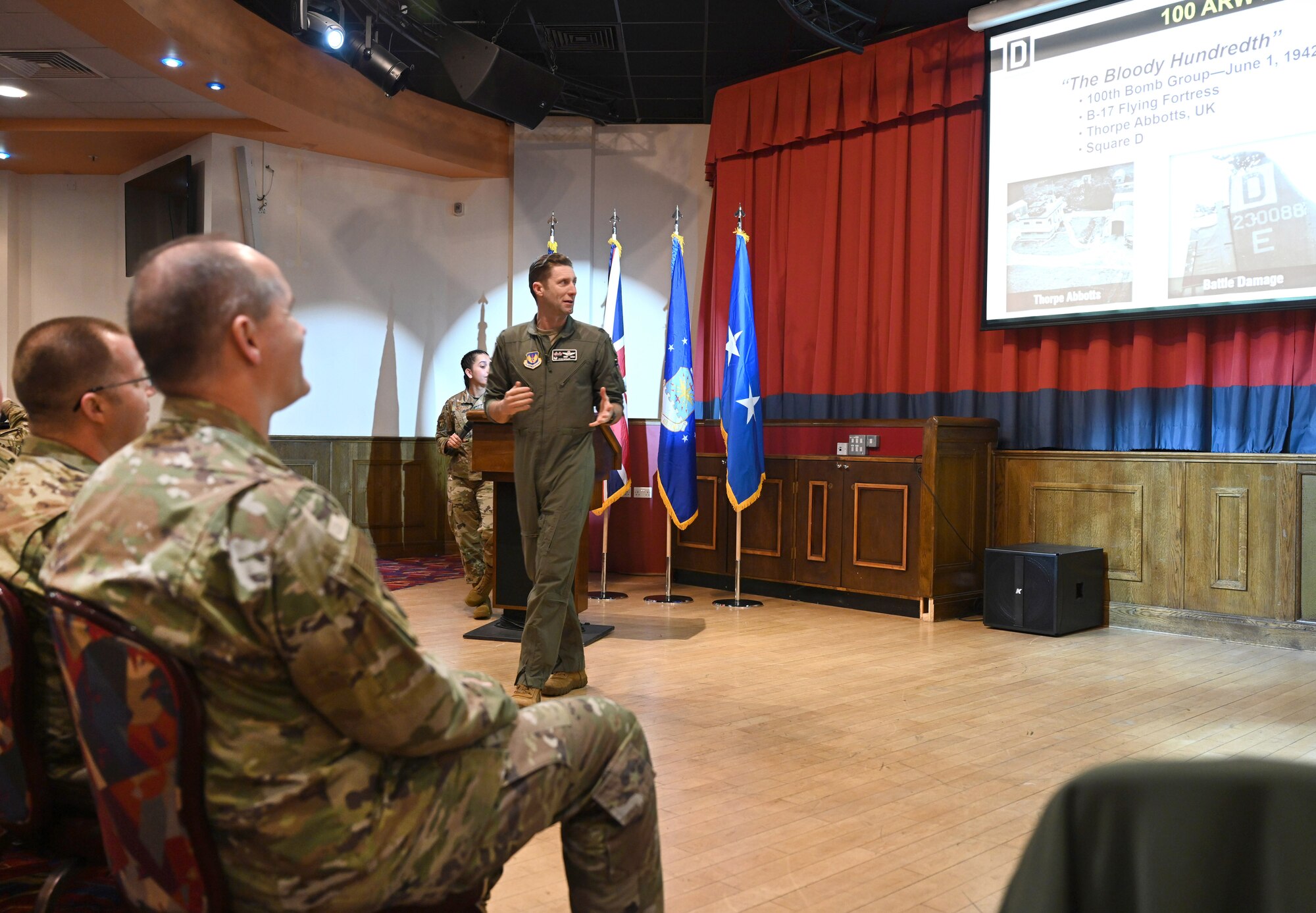 U.S. Air Force Col. Ryan Garlow, center, 100th Air Refueling Wing commander, gives a mission brief and overview of the 100th ARW mission, capabilities, readiness objectives, and history to the Air Force Personnel Center command team from Joint Base San Antonio-Randolph, Texas, at RAF Mildenhall, England, Jan. 23, 2025. The AFPC leadership team met with base leadership to increase awareness of talent management issues, enable better teamwork and execution, and receive feedback on how AFPC can better assist Airmen, Guardians and their families. (U.S. Air Force photo by Karen Abeyasekere)