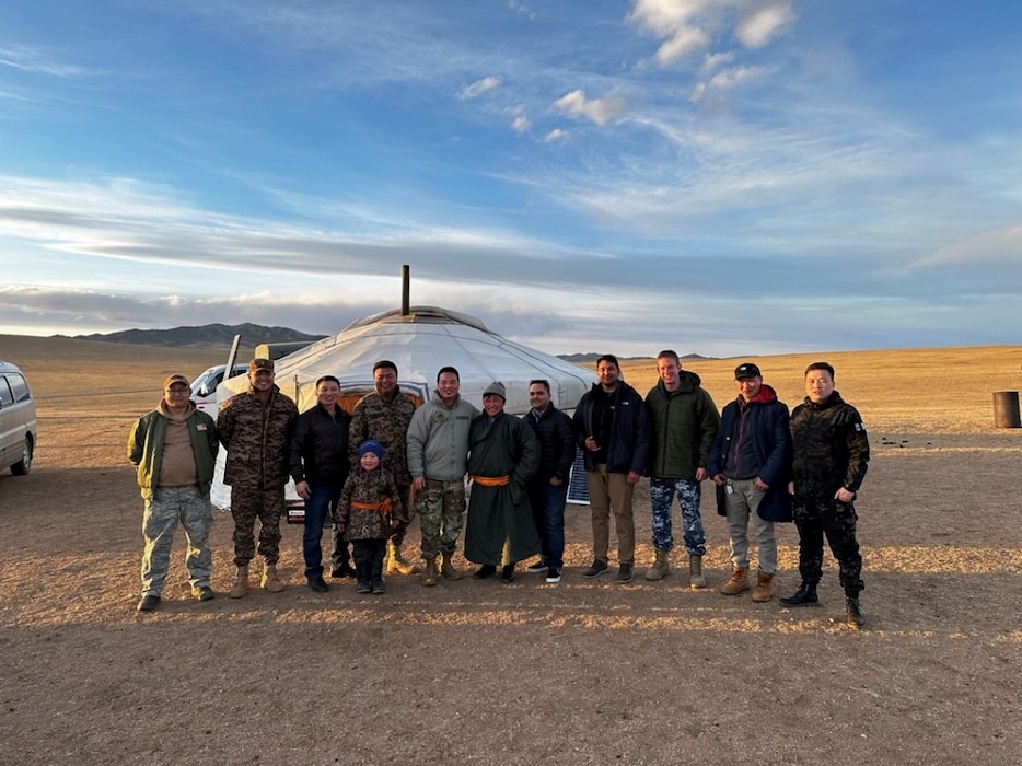 Pacific Angel exercise planners gathered in front of a traditional Mongolian nomadic dwelling, known as a "ger", following a social event hosted by local nationals.