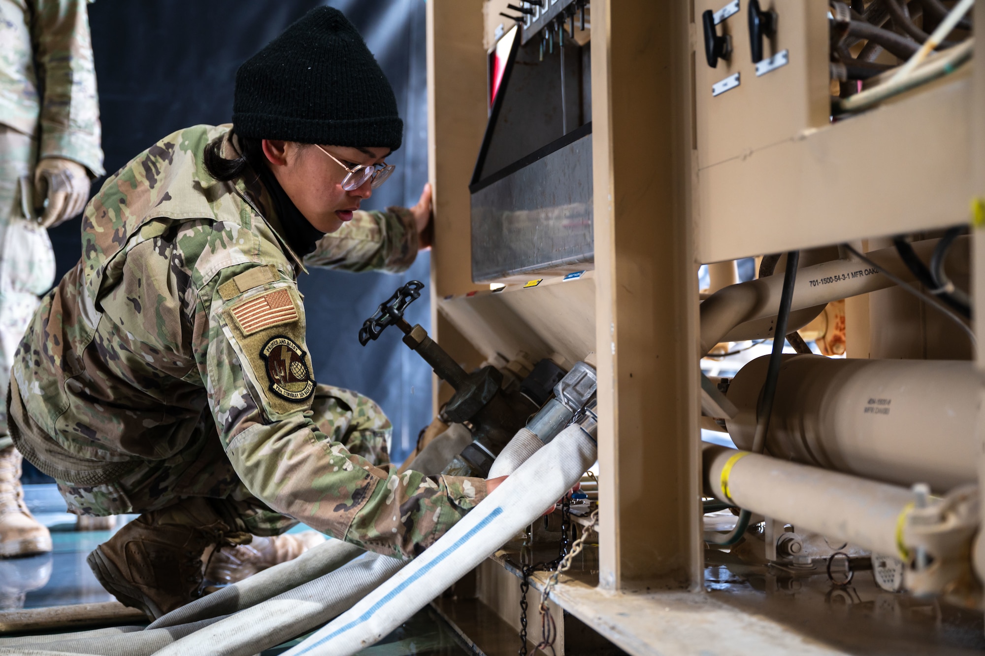 A U.S. Airman assigned to the 11th Air Task Force demonstrates how to adjust water valves at Tyndall Air Force Base, Florida, Jan. 21, 2025. Maintaining a steady flow of water conserves resources and allows for proper testing to occur. (U.S. Air Force photo by Senior Airman Jasmyne Bridgers-Matos)