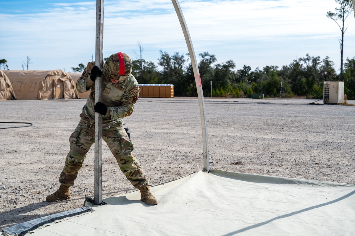 A U.S. Airman assigned to the 11th Air Task Force aligns a support beam for a tent at Tyndall Air Force Base, Florida, Jan. 21, 2025. Airmen were trained on proper construction techniques and best practices so that any individual had the capability of safely establishing necessary structures. (U.S. Air Force photo by Senior Airman Jasmyne Bridgers-Matos)