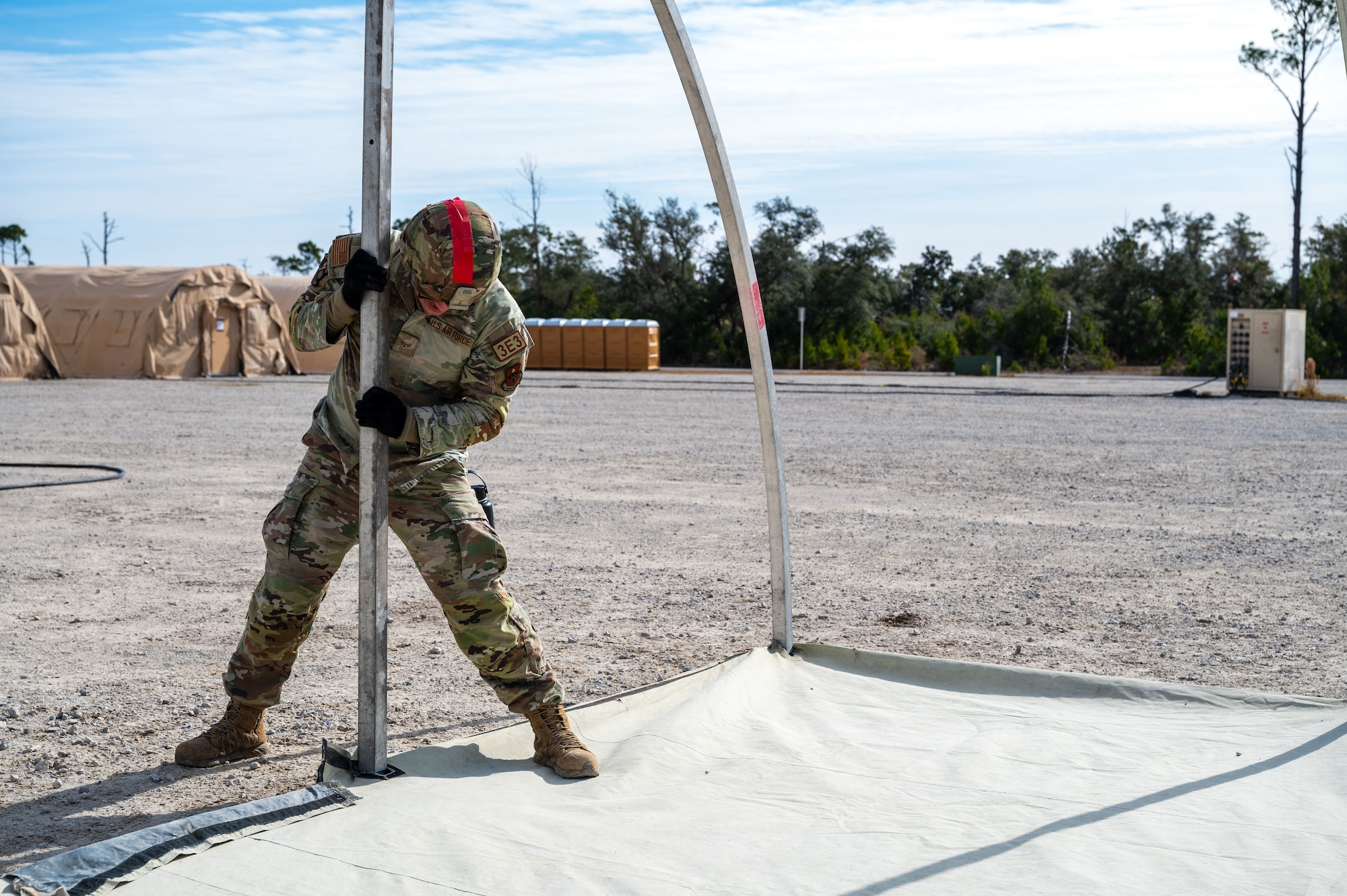 A U.S. Airman assigned to the 11th Air Task Force aligns a support beam for a tent at Tyndall Air Force Base, Florida, Jan. 21, 2025. Airmen were trained on proper construction techniques and best practices so that any individual had the capability of safely establishing necessary structures. (U.S. Air Force photo by Senior Airman Jasmyne Bridgers-Matos)