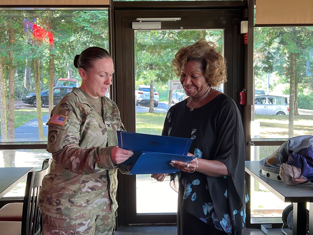 A woman is present an award.