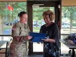 A woman is present an award.