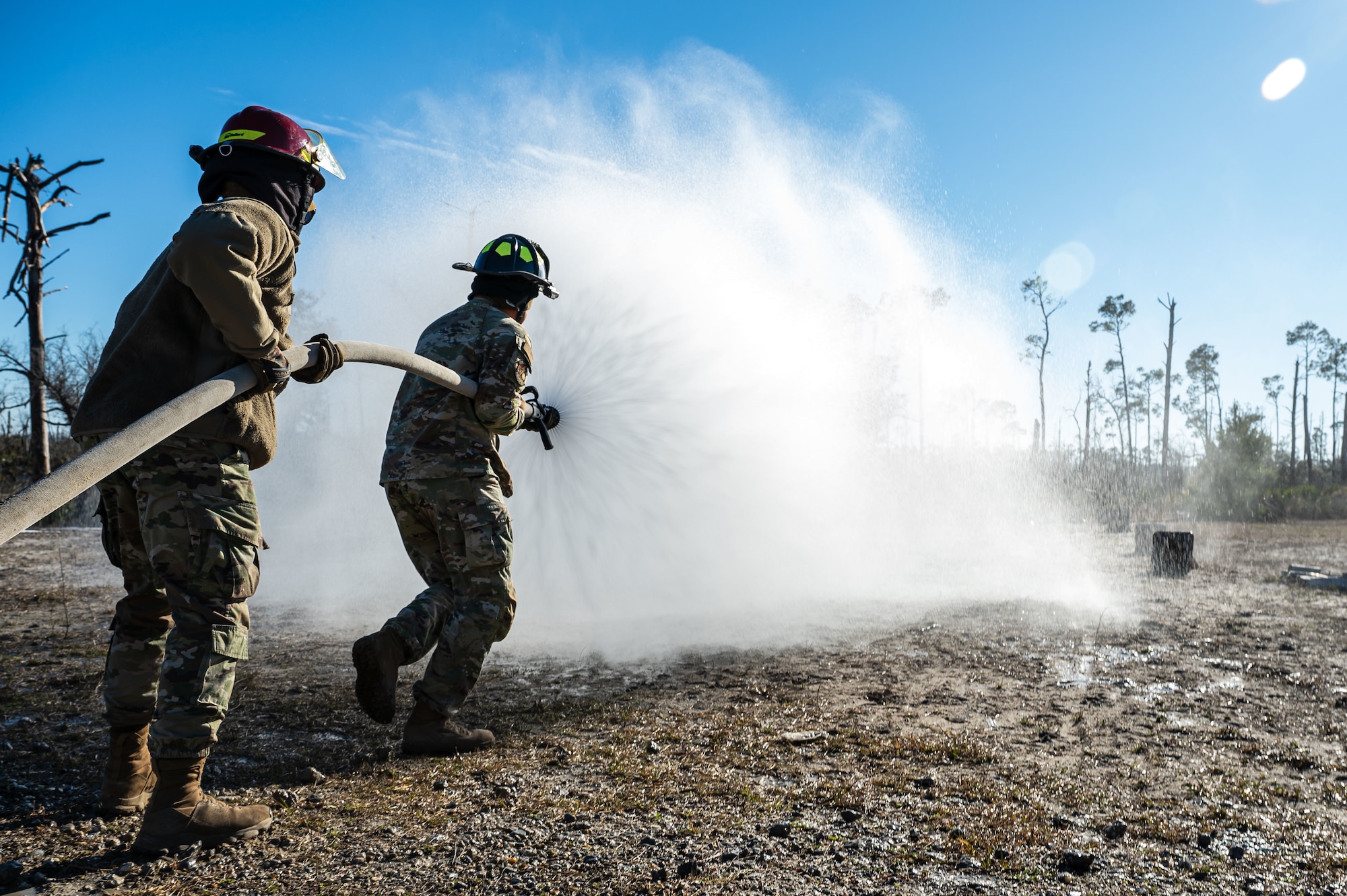U.S. Airmen assigned to the 11th Air Task Force clear a rescue path during personnel rescue and incident mitigation training at Tyndall Air Force Base, Florida, Jan. 23, 2025. Airmen were given notice of a simulated downed aircraft and cleared a path to ensure the pilot could safely be removed from the area. (U.S. Air Force photo by Senior Airman Jasmyne Bridgers-Matos)