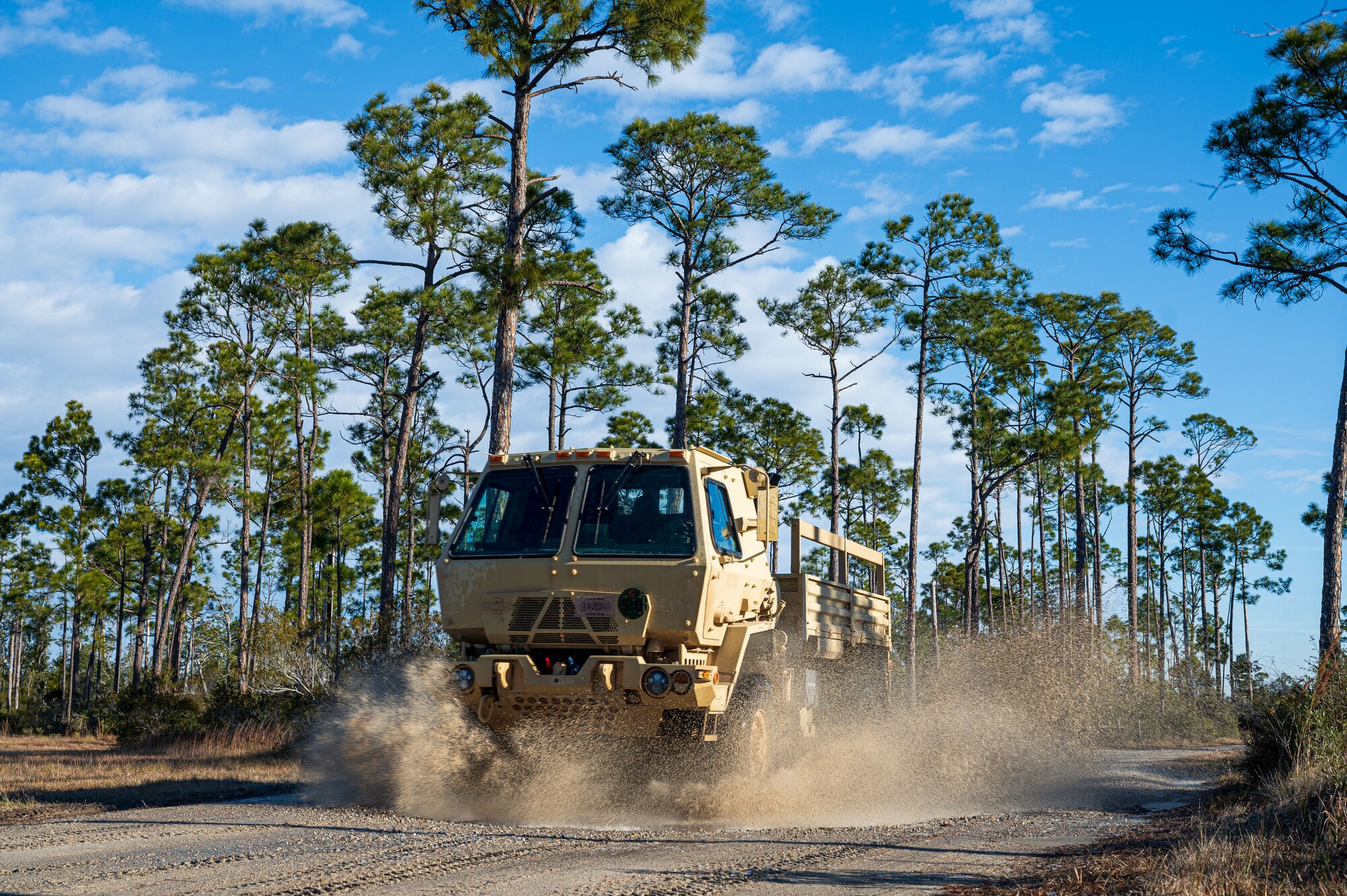 A U.S. Airman assigned to the 11th Air Task Force drives a light medium tactical vehicle to the convoy training site at Tyndall Air Force Base, Florida, Jan. 24, 2025. The training provided Airmen across various career fields experience driving large vehicles in different formations. (U.S. Air Force photo by Senior Airman Jasmyne Bridgers-Matos)