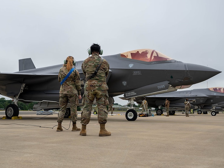 airmen marshals a jet